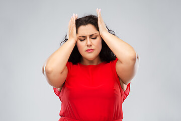 Image showing woman in red dress suffering from headache