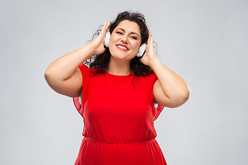 Image showing happy woman in headphones listening to music