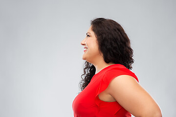 Image showing happy smiling woman in red dress looking up