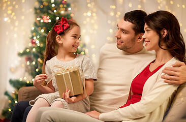 Image showing happy family with christmas present at home