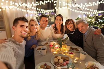 Image showing happy family taking selfie at tea party at home