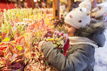 Image showing little girl choosing sweets at christmas market