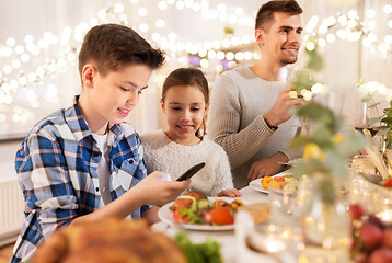 Image showing children with smartphone at family dinner party