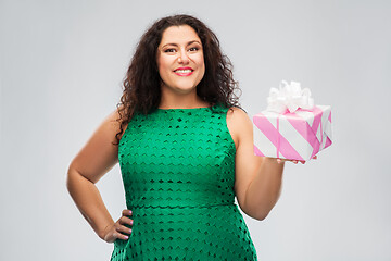 Image showing happy woman in green dress holding gift box