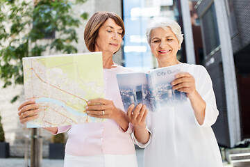 Image showing senior women with city guide and map on street