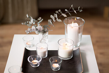 Image showing burning fragrance candles on table at cozy home