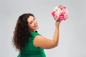 Image showing happy woman in green dress with flower bunch