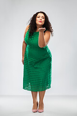 Image showing happy woman in green dress sending air kiss