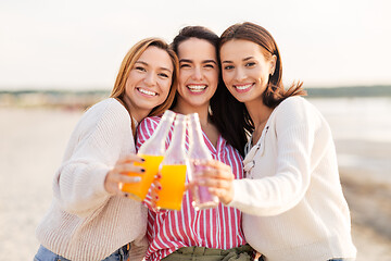 Image showing young women toasting non alcoholic drinks on beach