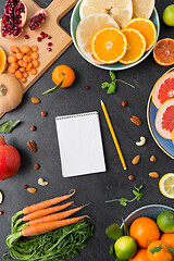 Image showing close up of notebook, fruits and vegetables