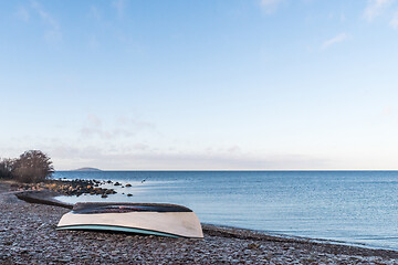 Image showing Rowboat overturned on land by seaside