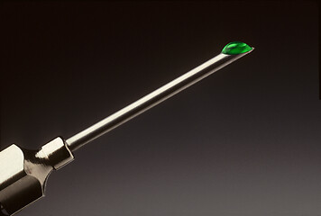 Image showing Drop of green liquid at the tip of a hypodermic needle