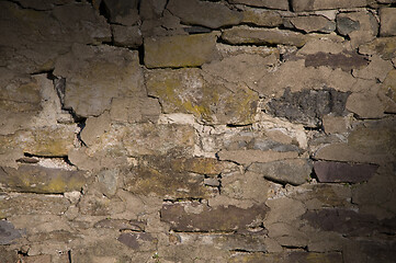 Image showing Cracked dilapidated masonry wall lit diagonally