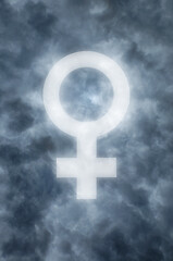Image showing Dark clouds with a glowing female symbol