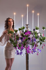 Image showing Young Woman And Chandelier With Flowers