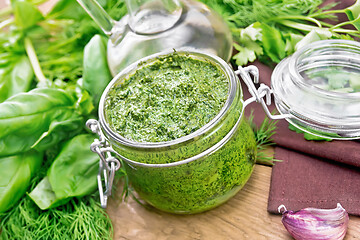 Image showing Sauce of spicy greens in jar on board