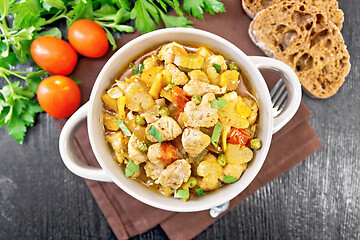 Image showing Chicken with vegetables and peas in saucepan on board top