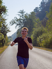 Image showing man jogging along a country road