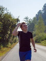 Image showing man jogging along a country road