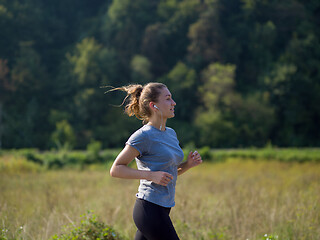 Image showing woman jogging along a country road