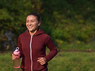 Image showing woman jogging along a country road