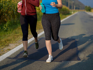 Image showing women jogging along a country road