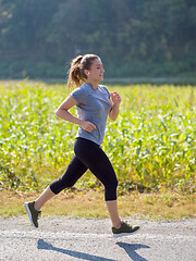 Image showing woman jogging along a country road