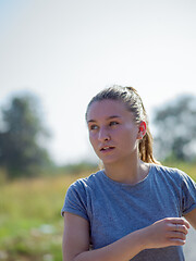 Image showing woman jogging along a country road