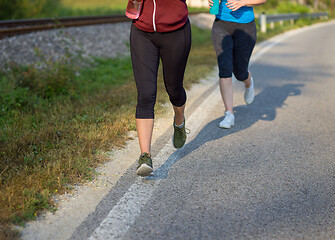 Image showing women jogging along a country road