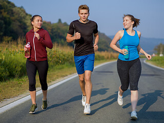 Image showing young people jogging on country road