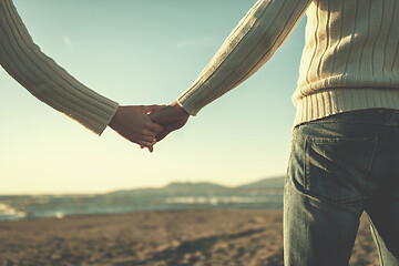 Image showing Loving young couple on a beach at autumn sunny day