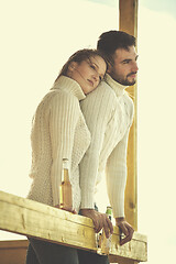 Image showing young couple drinking beer together at the beach