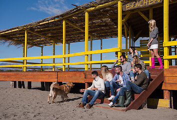 Image showing Group of friends having fun on autumn day at beach