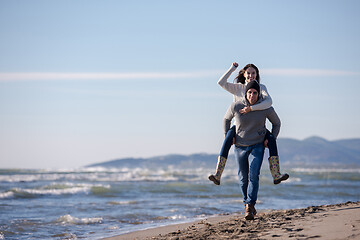 Image showing couple having fun at beach during autumn