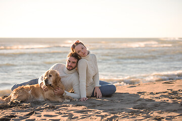 Image showing Couple with dog enjoying time on beach