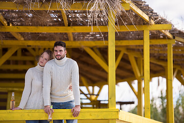 Image showing young couple drinking beer together at the beach