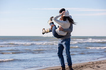 Image showing Loving young couple on a beach at autumn sunny day