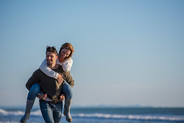 Image showing couple having fun at beach during autumn