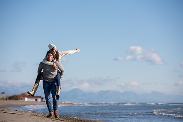 Image showing couple having fun at beach during autumn