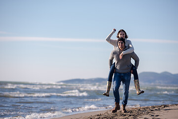 Image showing couple having fun at beach during autumn