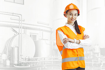 Image showing Destroying gender stereotypes. Female builder standing against industrial background