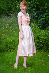 Image showing Elegant in a dirndl on the meadow
