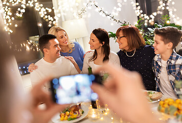 Image showing family having dinner party and taking selfie