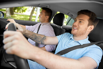 Image showing car driving school instructor and male driver