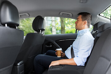 Image showing businessman with takeaway coffee on car back seat