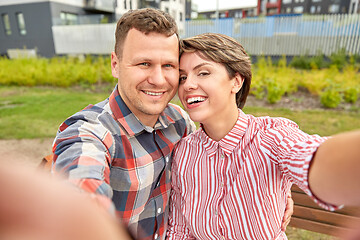 Image showing happy couple in park taking selfie outdoors