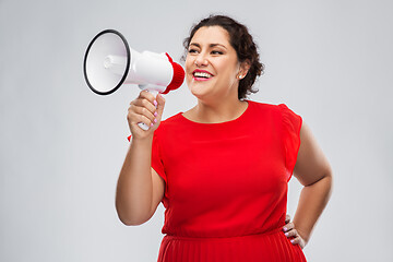 Image showing happy woman in red dress speaking to megaphone