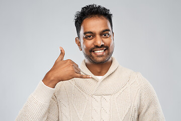 Image showing indian man in knitted sweater over gray background