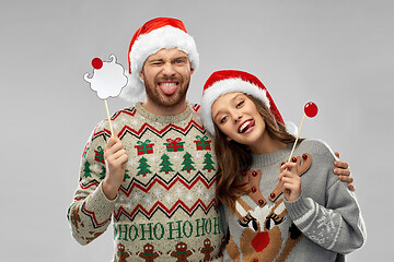 Image showing couple with christmas party props in ugly sweaters