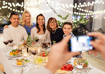 Image showing family photographing by smartphone at dinner party